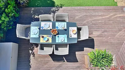 an overhead view of a table and chairs on a deck at L'Éclat d'Azur in Nice