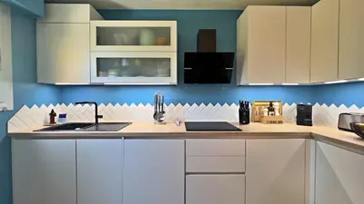 a kitchen with white cabinets and a sink at L'Éclat d'Azur in Nice