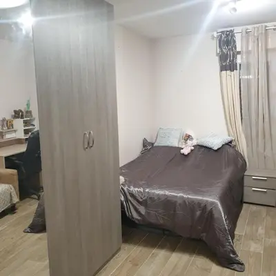 a bedroom with a large cabinet next to a bed at CHAMBRE CHEZ L HABITANT AVEC SDB ET WC sans cuisine in Nice