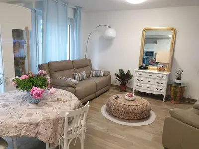 a living room with a couch and a table at CHAMBRE CHEZ L HABITANT AVEC SDB ET WC sans cuisine in Nice