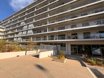 an empty parking lot in front of an apartment building at SEASIDE VIEW Saint Laurent in Saint-Laurent-du-Var
