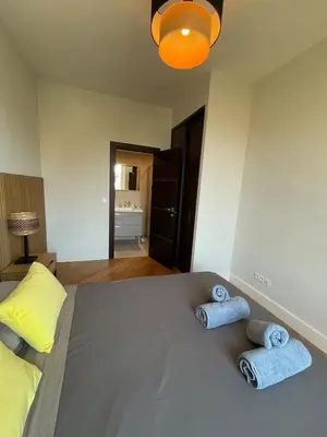 two towels on a bed with two pillows at Villa Katerina - Luxury Apartment in Nice