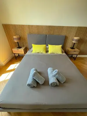 a bedroom with a large bed and a window at Villa Katerina - Luxury Apartment in Nice