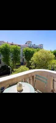 a table and a chair on a balcony at Le Grand Bourgeois à Nice in Nice