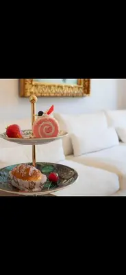 two plates of food on a tray on a bed at Le Grand Bourgeois à Nice in Nice