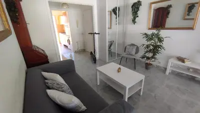 a living room with a couch and a table at Beautiful 2 bedroom apartment Port - 5 min to beaches in Nice