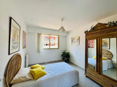 a bedroom with a large mirror and a bed at Beautiful 2 bedroom apartment Port - 5 min to beaches in Nice