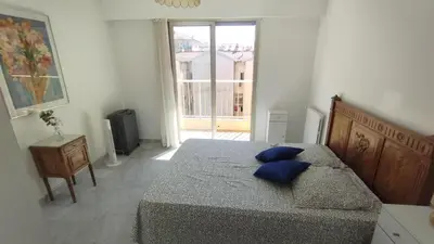 a bedroom with a bed with blue pillows on it at Beautiful 2 bedroom apartment Port - 5 min to beaches in Nice