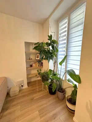 a living room with potted plants and a book shelf at Heart of Nice Beautiful apartment 3 bedrooms in Nice