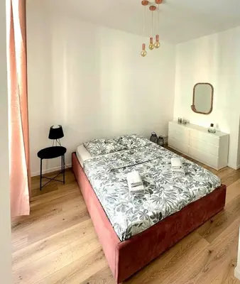 a bedroom with a bed and a mirror and a chair at Heart of Nice Beautiful apartment 3 bedrooms in Nice