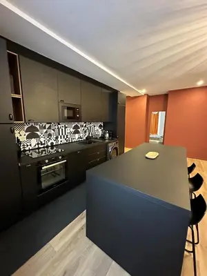 a kitchen with black cabinets and a counter top at Heart of Nice Beautiful apartment 3 bedrooms in Nice