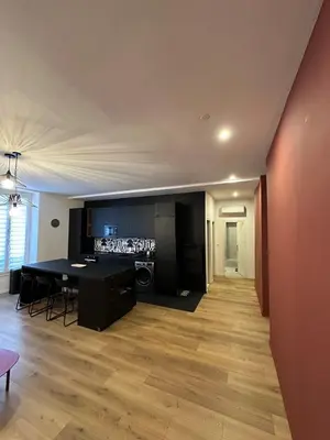 a living room with a black table and a kitchen at Heart of Nice Beautiful apartment 3 bedrooms in Nice