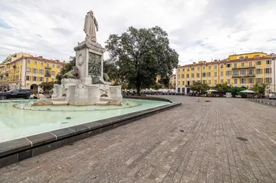 a statue in the middle of a street with buildings at Residence Garibaldi - Nice in Nice