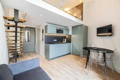 a kitchen and dining room with a table in a room at Residence Garibaldi - Nice in Nice