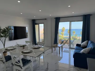 a dining room with a table and a view of the ocean at Sea View, Modern Apartment and Terrace in Nice