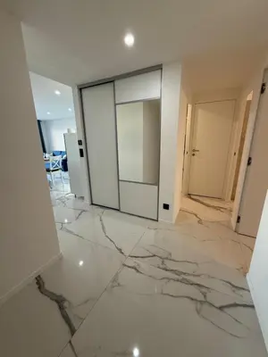 a living room with marble floors and a glass door at Sea View, Modern Apartment and Terrace in Nice