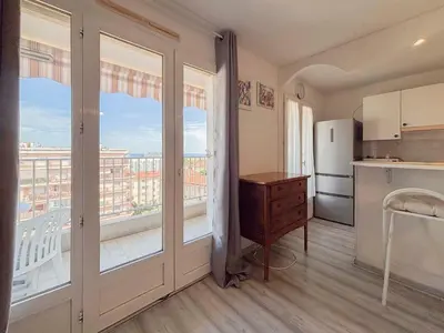 a kitchen with a large window and a refrigerator at Douceur azuréenne - Wifi, Parking, vue mer, 4pers in Nice