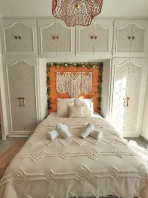 a bedroom with a large bed with pillows on it at Studio Jungle Bohème - à 3 min de la Promenade des anglais à pieds in Nice