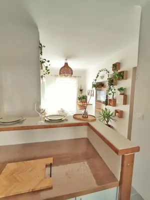 a kitchen with a wooden counter top and a window at Studio Jungle Bohème - à 3 min de la Promenade des anglais à pieds in Nice