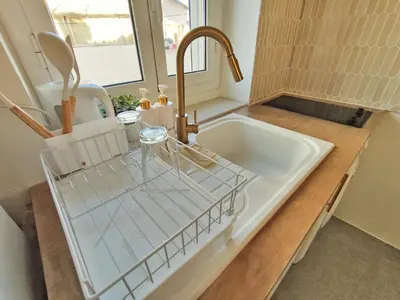 a kitchen sink with a faucet and a sink at Studio Jungle Bohème - à 3 min de la Promenade des anglais à pieds in Nice