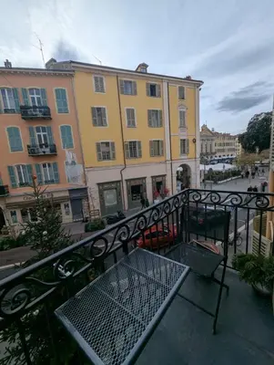 a balcony with a bench and a building at Beautiful luxurious apartment in Nice