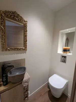 a bathroom with a sink and a toilet and a mirror at Beautiful luxurious apartment in Nice
