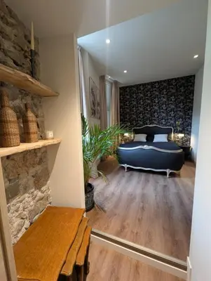 a bedroom with a blue bed and a wooden bench at Beautiful luxurious apartment in Nice