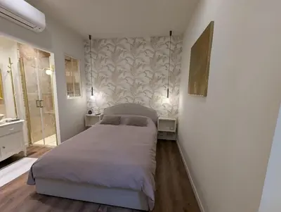 a bedroom with a large bed in a room at Beautiful luxurious apartment in Nice