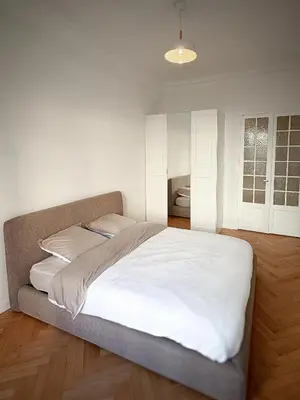 a bedroom with a large bed with white sheets at Nice Center - Spacious Luxury Apartment with Air Conditioning in Nice