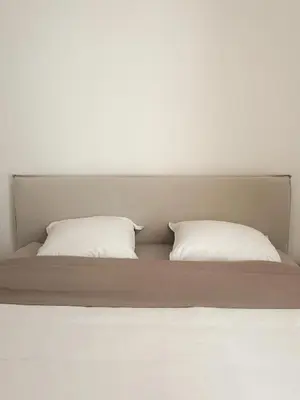 two white pillows sitting on top of a bed at Nice Center - Spacious Luxury Apartment with Air Conditioning in Nice