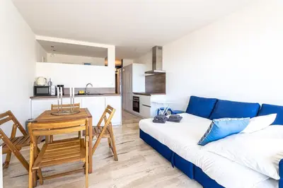a living room with a blue couch and a table at Azzuro - Mare e Terrazza in Nice