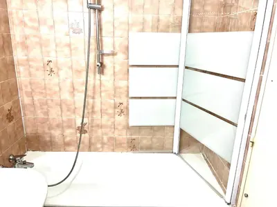 a shower with a glass door in a bathroom at Studio Californie in Nice