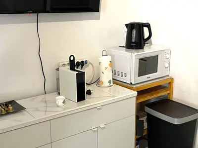 a kitchen with a microwave and a coffee maker on a counter at Studio Californie in Nice