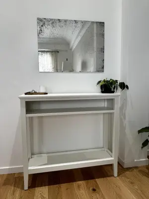 a white dressing table with a mirror on a wall at Carré d'Or - 2P Cosy avec Terrasse et véranda in Nice