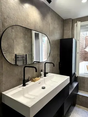 a bathroom with a white sink and a mirror at Carré d'Or - 2P Cosy avec Terrasse et véranda in Nice