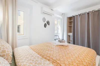 a bedroom with a bed and a window at Nice Renting - 6C FRANCE - Chic Stay Pedestrian Zone Sea Massena in Nice