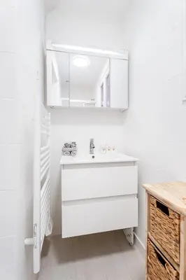 a white bathroom with a sink and a mirror at Nice Renting - 6C FRANCE - Chic Stay Pedestrian Zone Sea Massena in Nice
