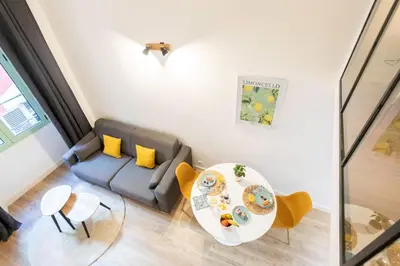 a living room with a couch and a table at Duplex cosy dans la Vieille Ville in Nice