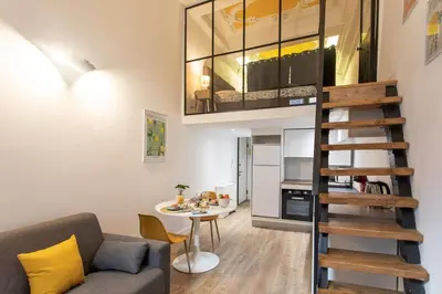 a living room with a couch and a table at Duplex cosy dans la Vieille Ville in Nice