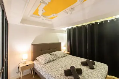 a bedroom with a bed with two brown crosses on it at Duplex cosy dans la Vieille Ville in Nice