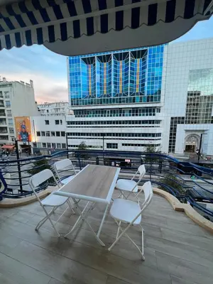 a table and chairs on a balcony with buildings at Superbe appart près de la mer in Nice