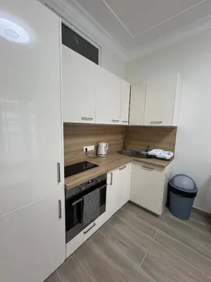 a kitchen with white cabinets and a sink at Superbe appart près de la mer in Nice