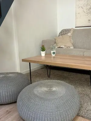 a living room with a coffee table and a couch at Studio proche gare in Nice
