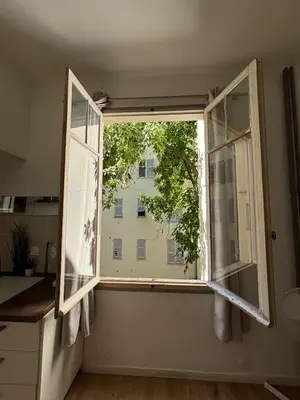 a window in a kitchen with a view of a building at Studio proche gare in Nice