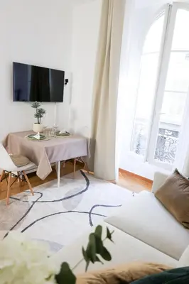 a living room with a couch and a table at Carre d'OR Massena luxury apartment in Nice