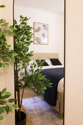 a bedroom with a bed and a mirror at Carre d'OR Massena luxury apartment in Nice