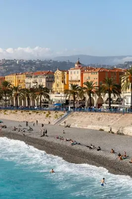 a group of people on a beach with buildings at Carre d'OR Massena luxury apartment in Nice