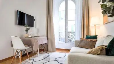 a living room with a couch and a table and a window at Carre d'OR Massena luxury apartment in Nice