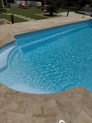 a large blue swimming pool with blue water at Charmant appartement, piscine 15 min de Nice in Carros
