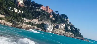 a mountain with houses on it next to the ocean at Studio Rue Bonaparte in Nice